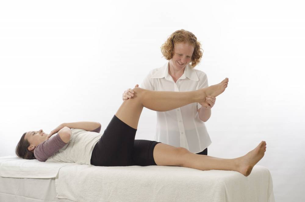 A physical therapist performing physical therapy.